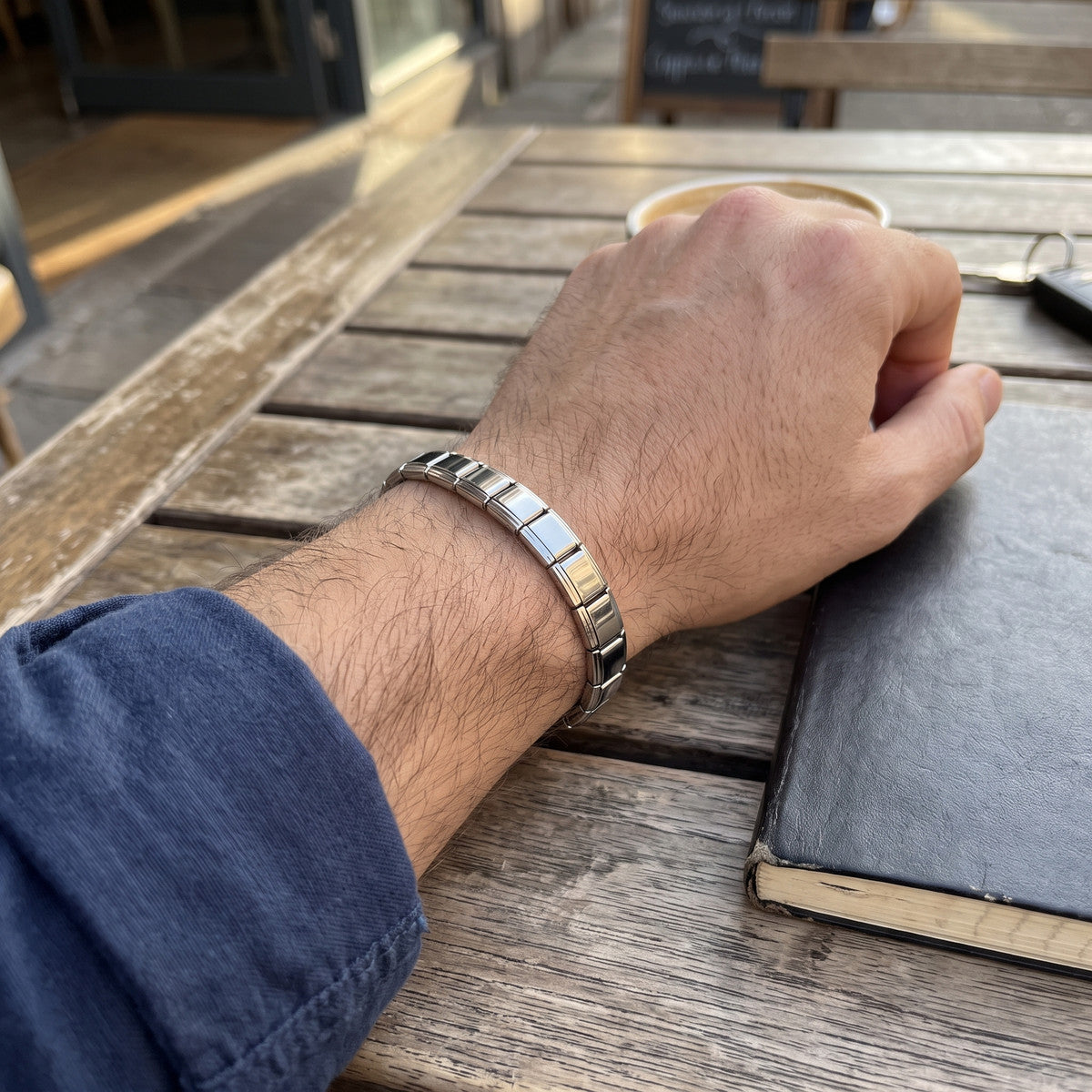 Ben showing a bracelet wrist at a cafe